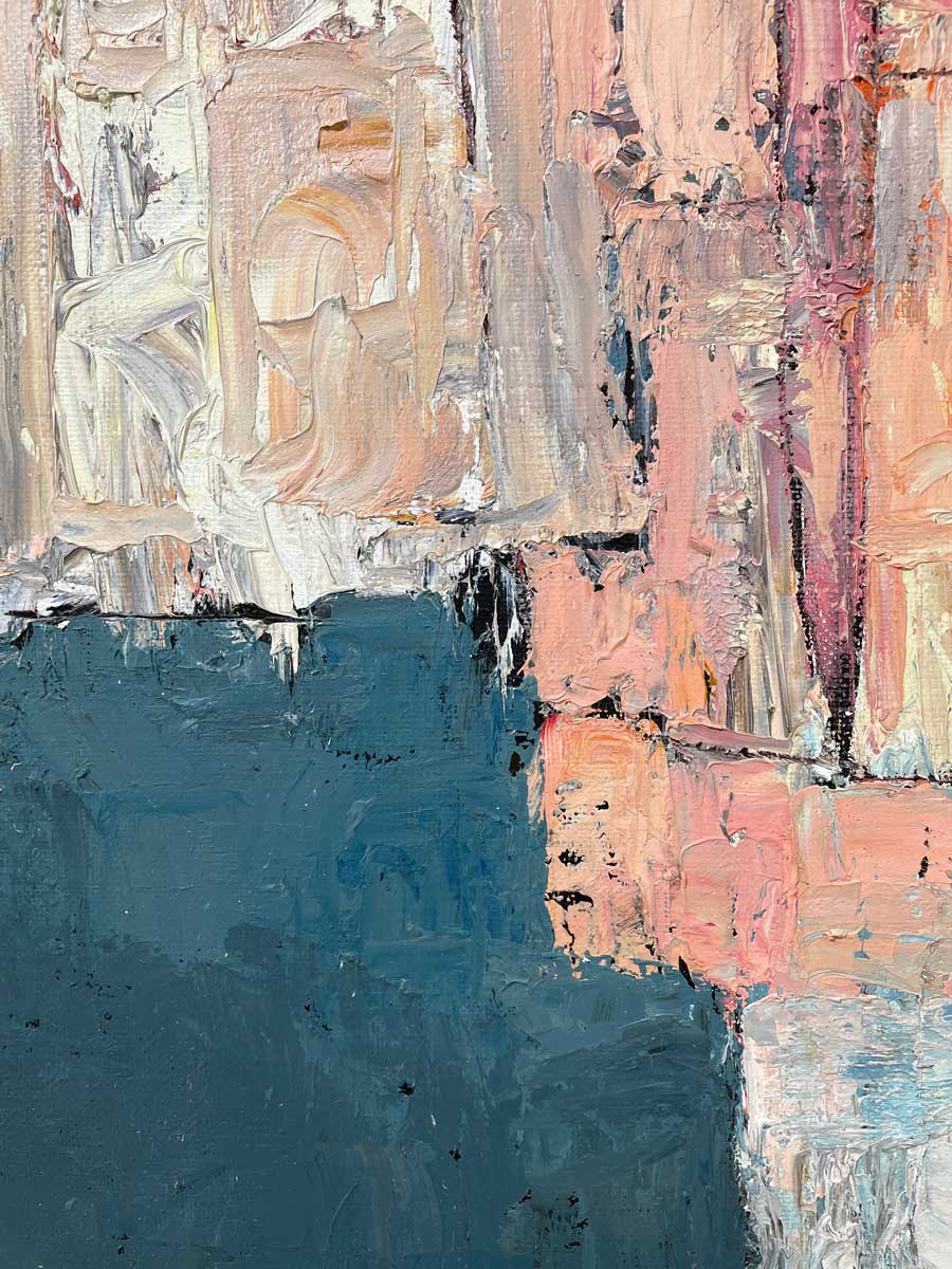 A close up of the texture of white, light pink and dark teal paint.