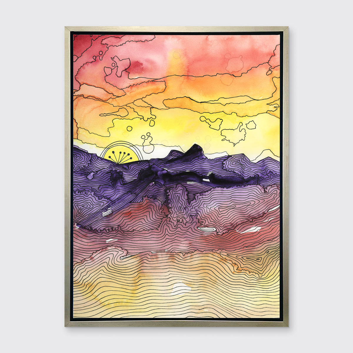 A red, orange, yellow, purple and black abstract landscape print in a silver floater frame hangs on a white wall.
