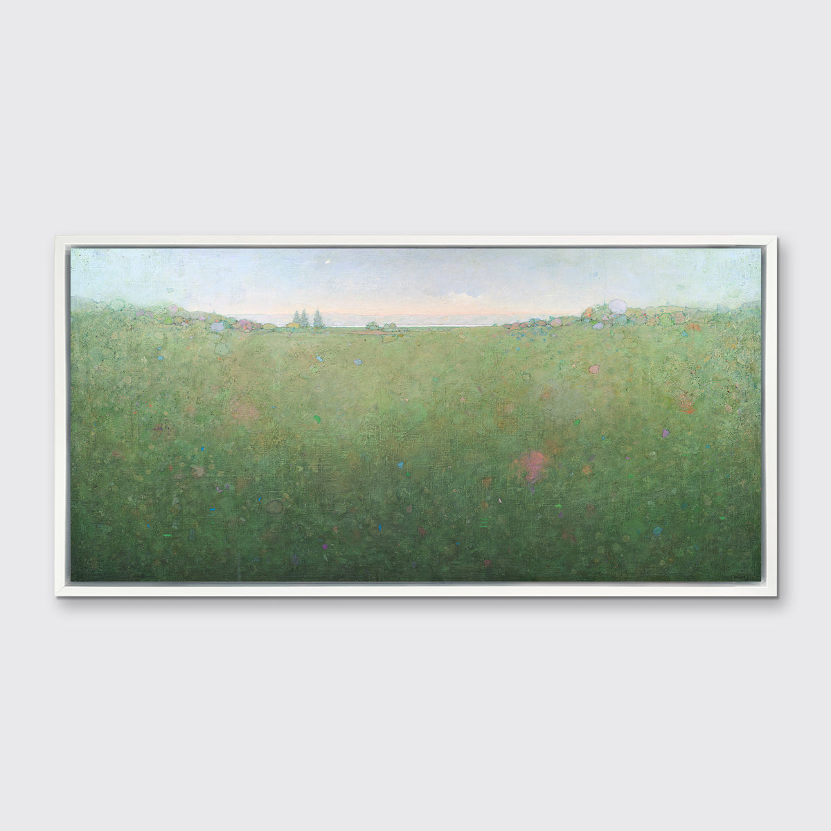 A green abstract landscape print in a white floater frame hangs on a white wall.