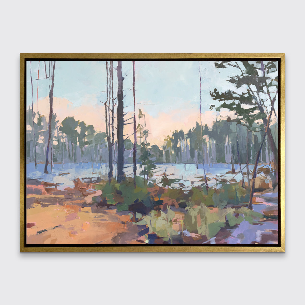 A light blue, green, brown and purple abstract landscape print in a gold floater frame hangs on a white wall.