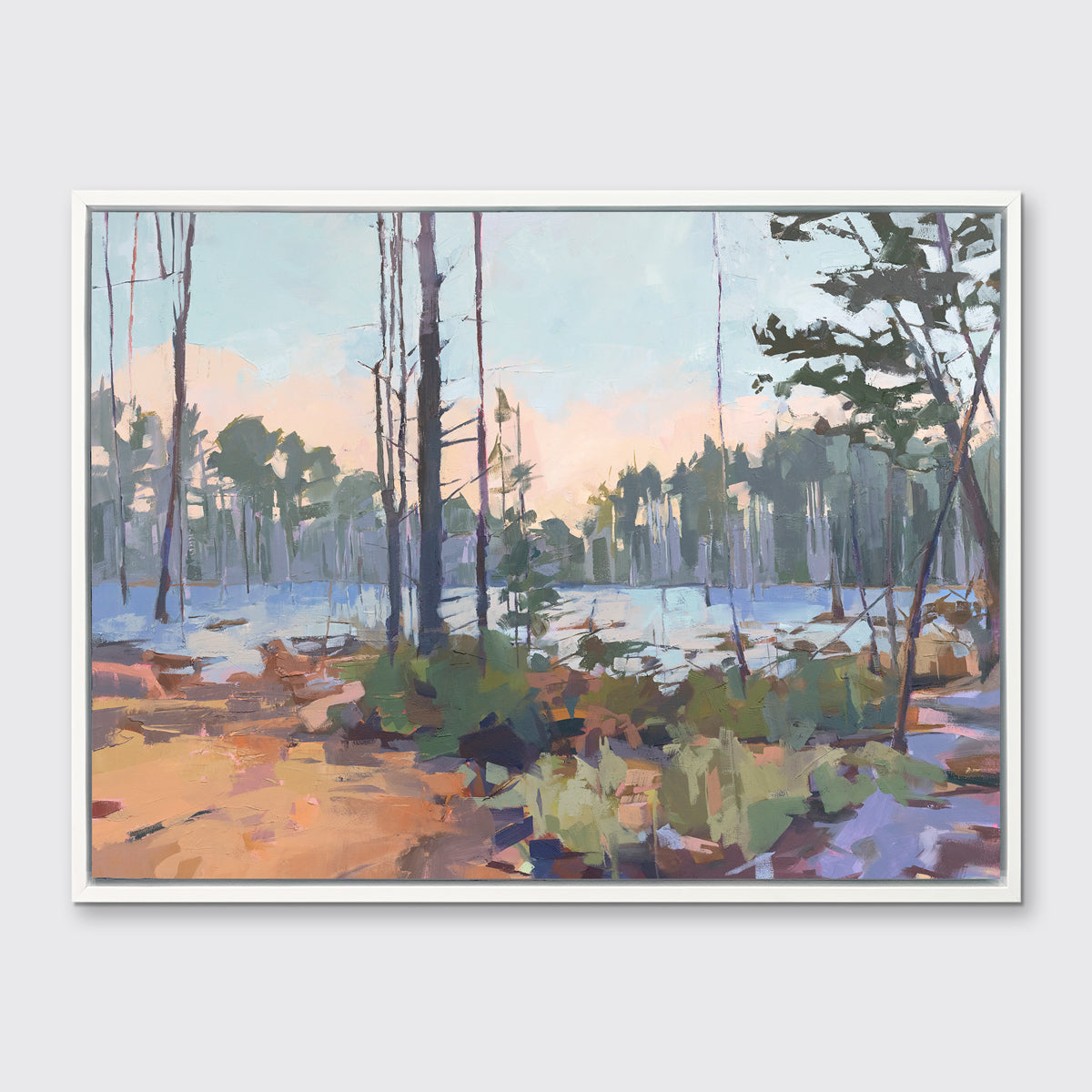 A light blue, green, brown and purple abstract landscape print in a white floater frame hangs on a white wall.