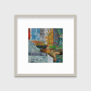 A multicolored abstract print of a flying eagle in a silver frame with a mat hangs on a white wall.