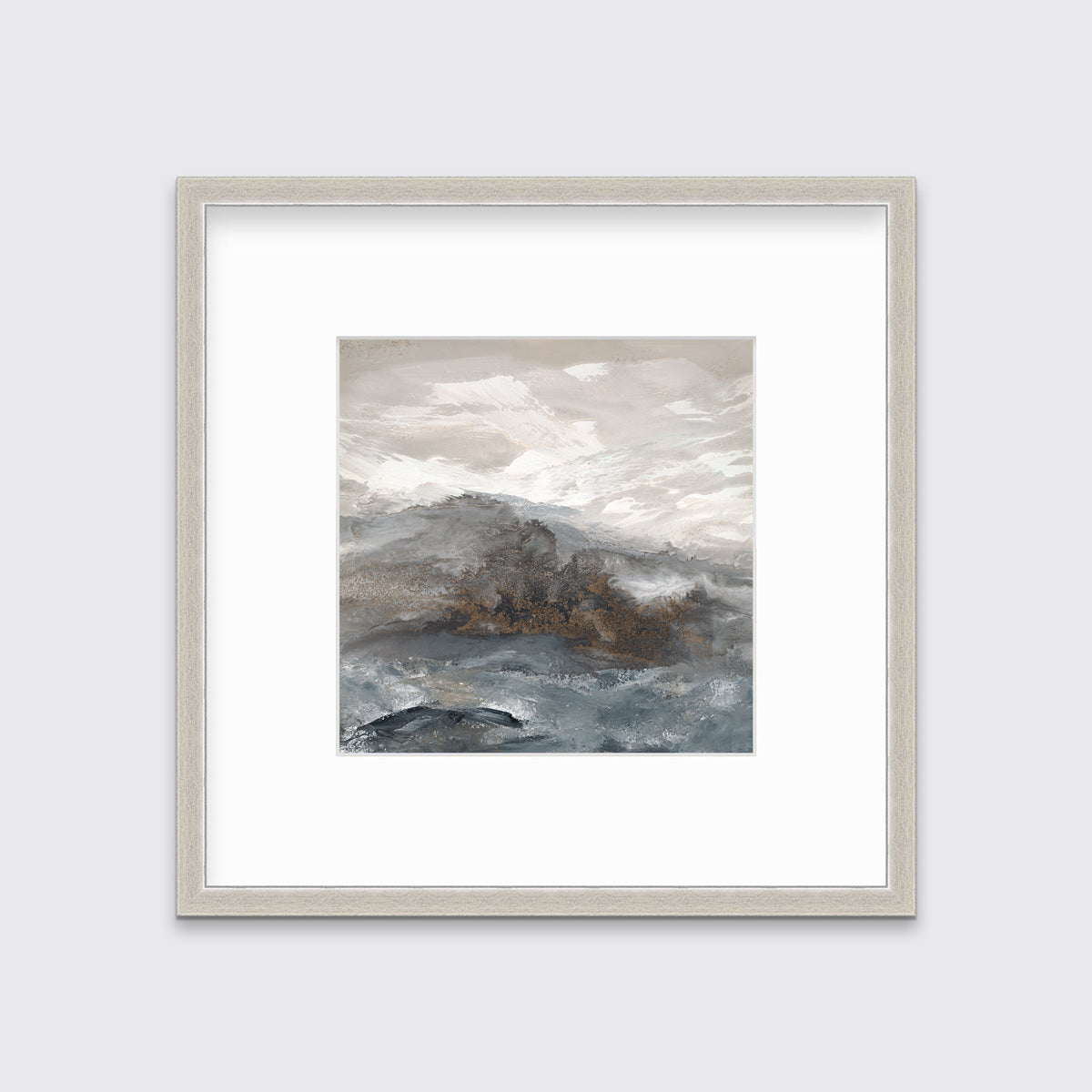 A beige, white, brown and grey abstract print in a silver frame with a mat hangs on a white wall.