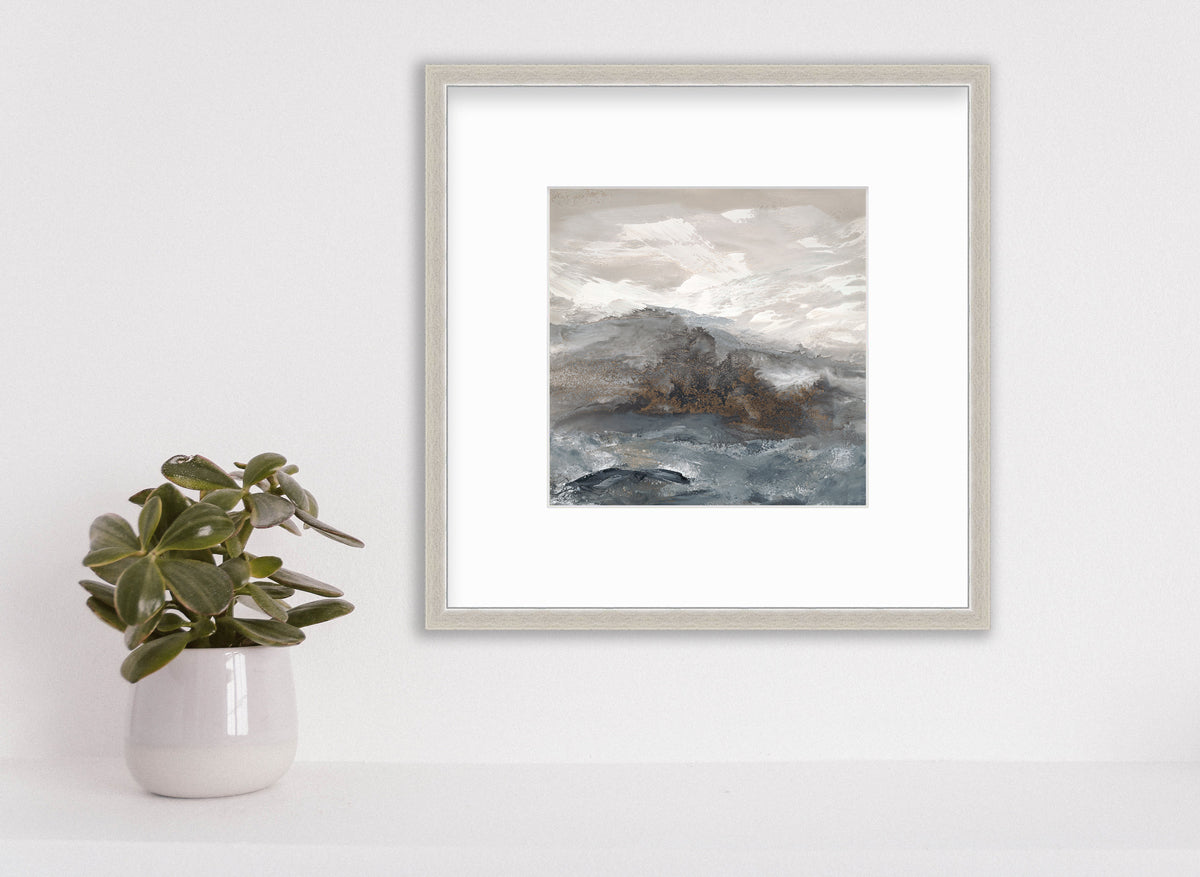 A beige, white, brown and grey abstract print in a silver frame with a mat hangs on a white wall above a small potted plant.