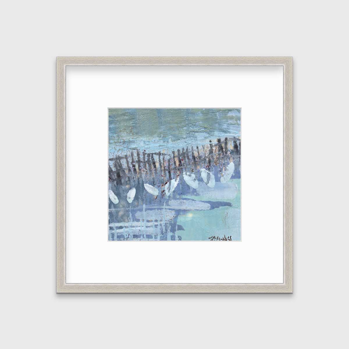 A blue, lavender and olive green abstract print in a silver frame with a mat hangs on a white wall.