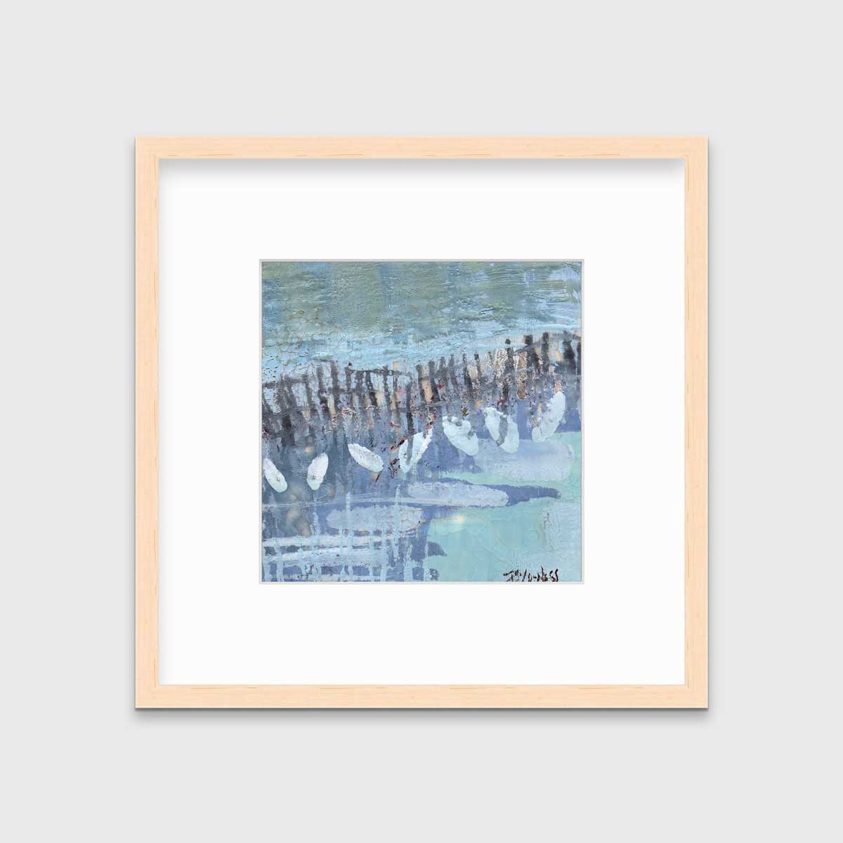 A blue, lavender and olive green abstract print in a natural wood frame with a mat hangs on a white wall.