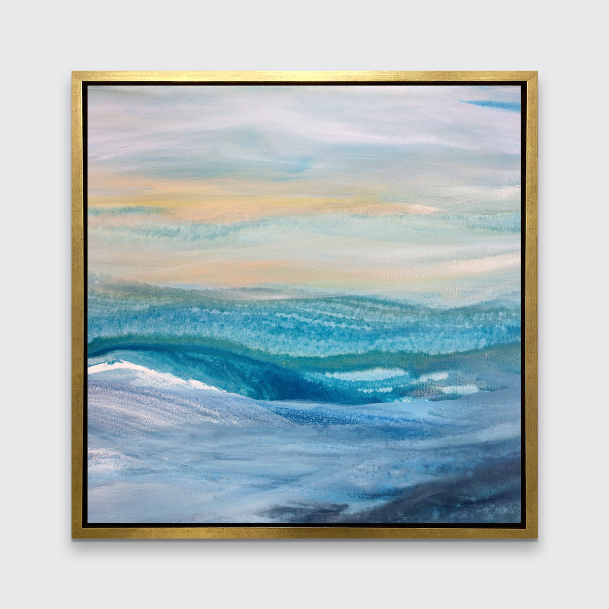 A blue, teal, yellow and white abstract print in a gold floater frame hangs on a white wall.
