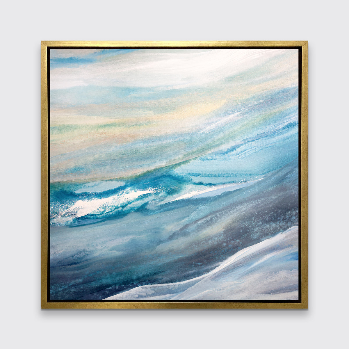 A blue, teal, yellow and white abstract print in a gold floater frame hangs on a white wall.