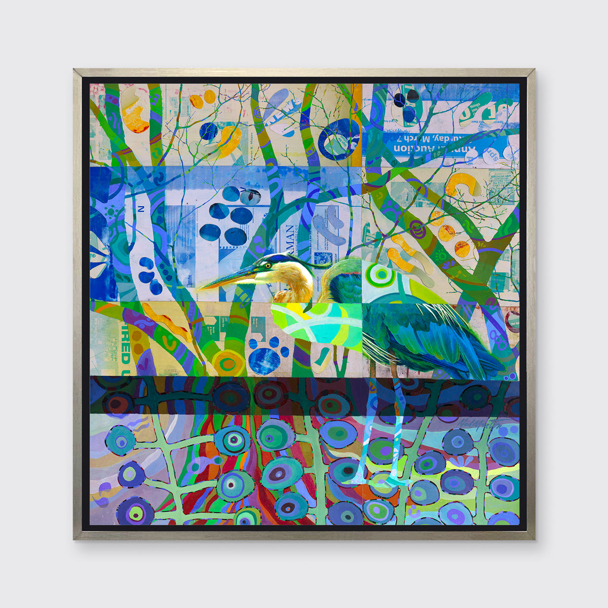 A multicolored abstract print of a bird in a silver floater frame hangs on a white wall.