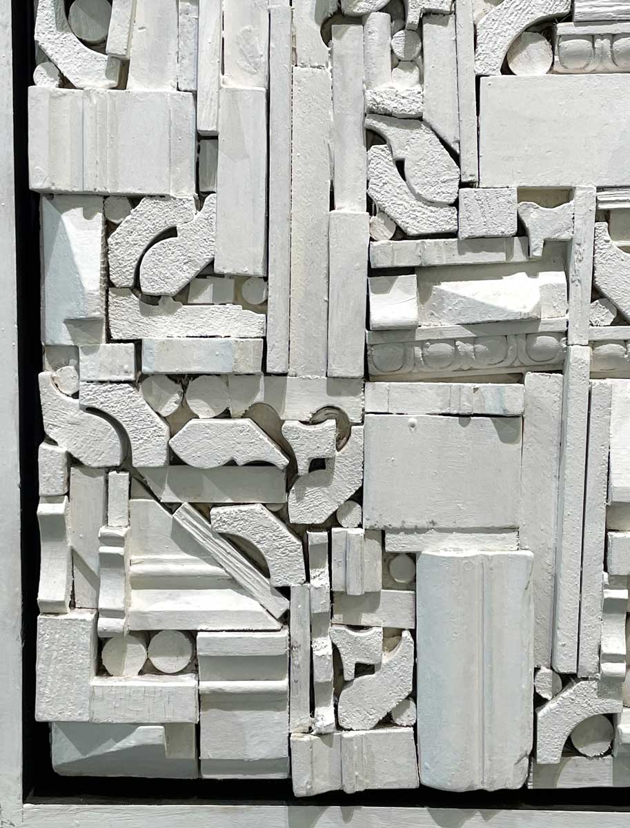 A close up of the white wooden shapes.