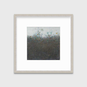 A dark olive green abstract landscape print in a silver frame with a mat hangs on a white wall.