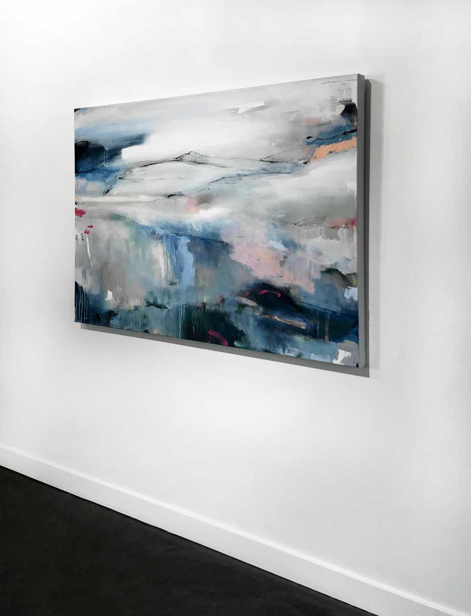 A right side-angle view of an abstract painting by Kelly Rossetti hangs on a white wall.