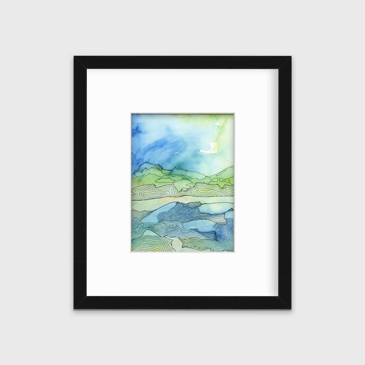 A green and blue abstract landscape illustration print in a black frame with a mat hangs on a white wall.