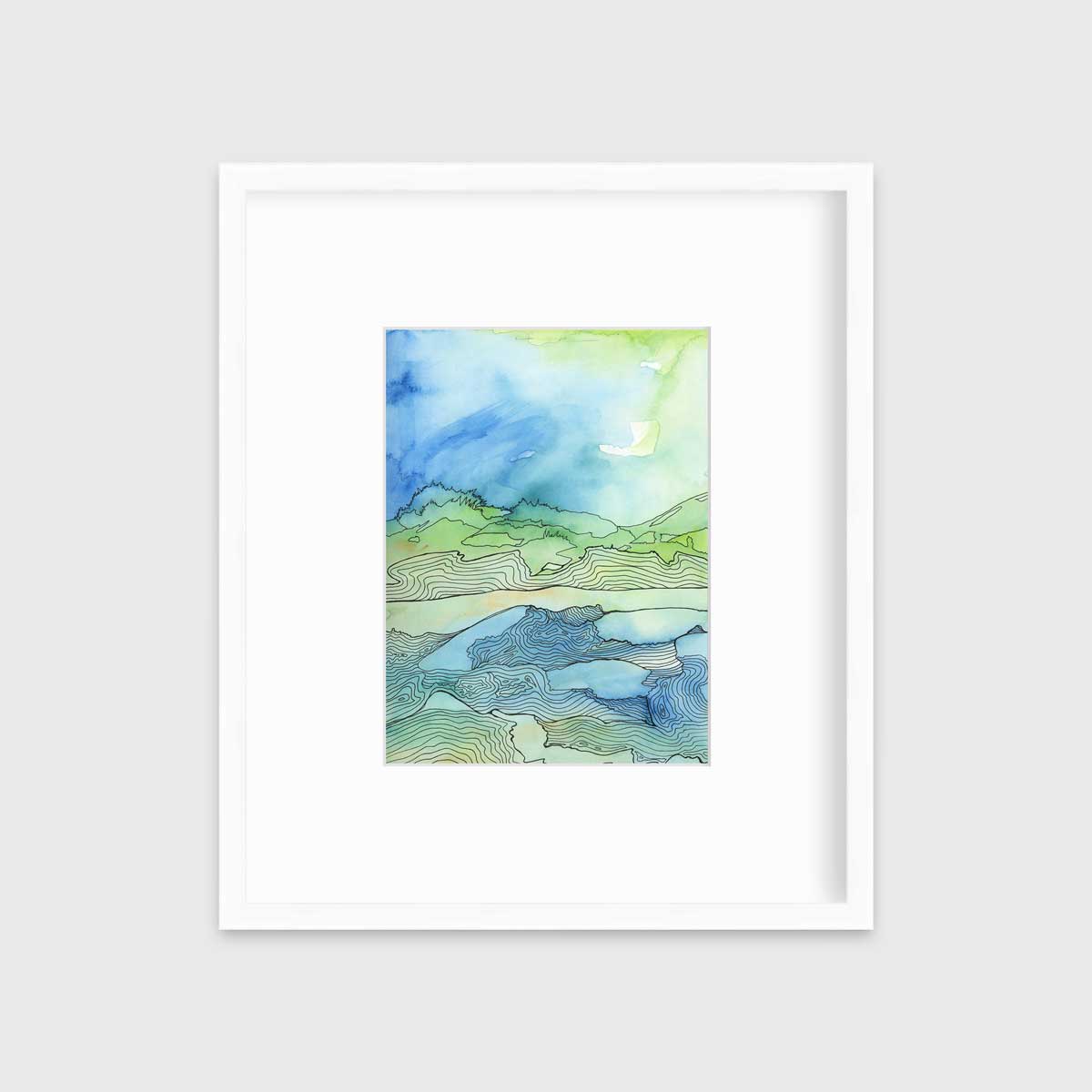 A green and blue abstract landscape illustration print in a white frame with a mat hangs on a white wall.
