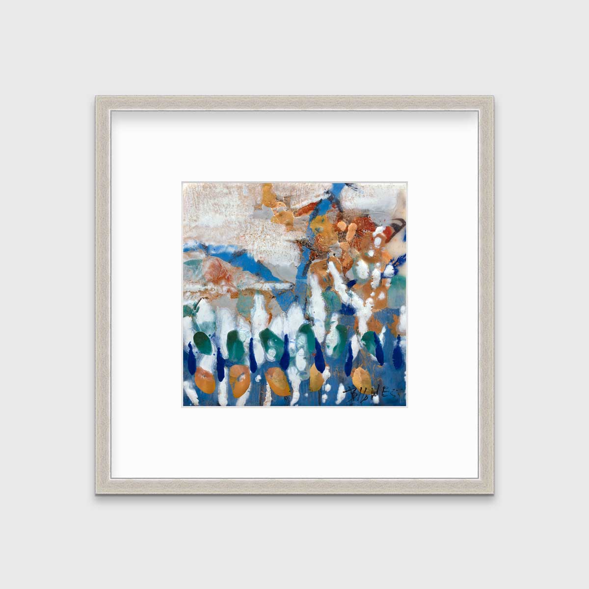 A multicolored abstract print in a silver frame with a mat hangs on a white wall.