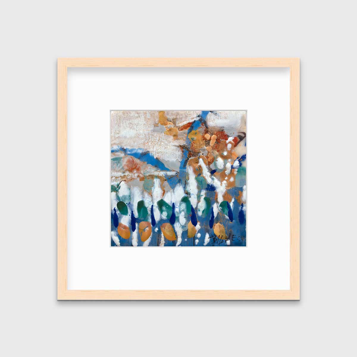 A multicolored abstract print in a natural wood frame with a mat hangs on a white wall.