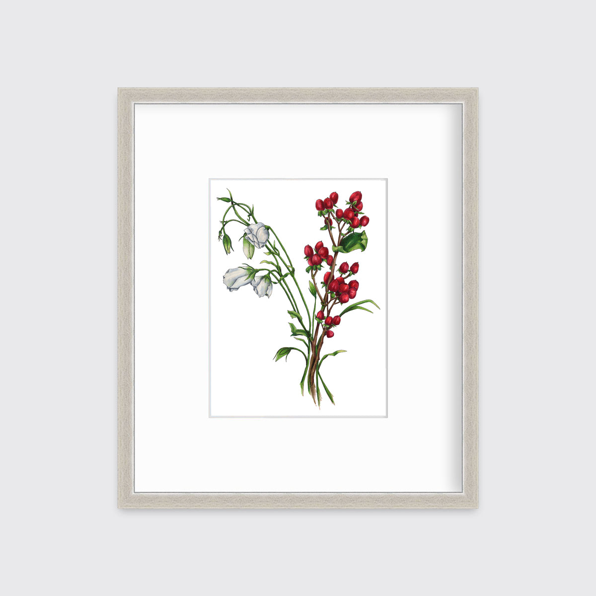 A print of white and red flowers hangs in a silver frame on a white frame.