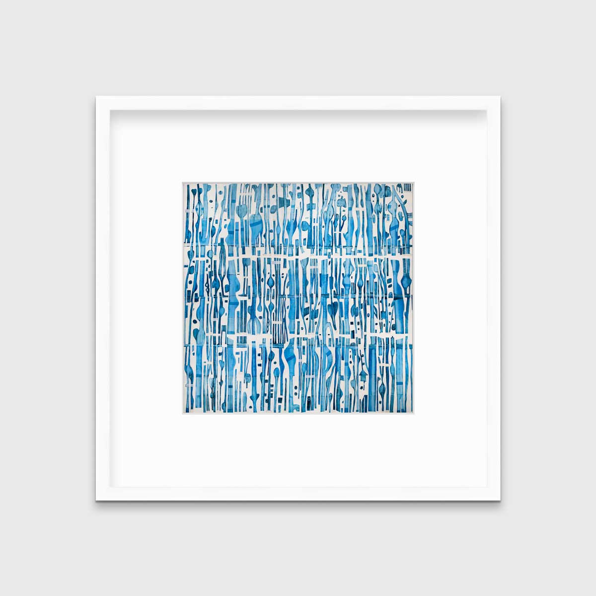 A blue and white abstract print in a white frame with a mat hangs on a white wall.