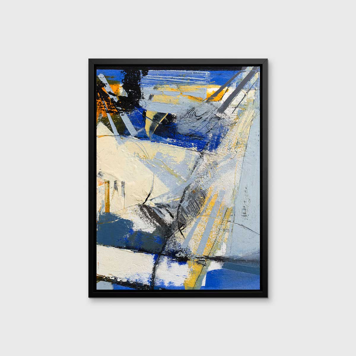 A blue, white, yellow and black abstract print in a black floater frame hangs on a white wall.