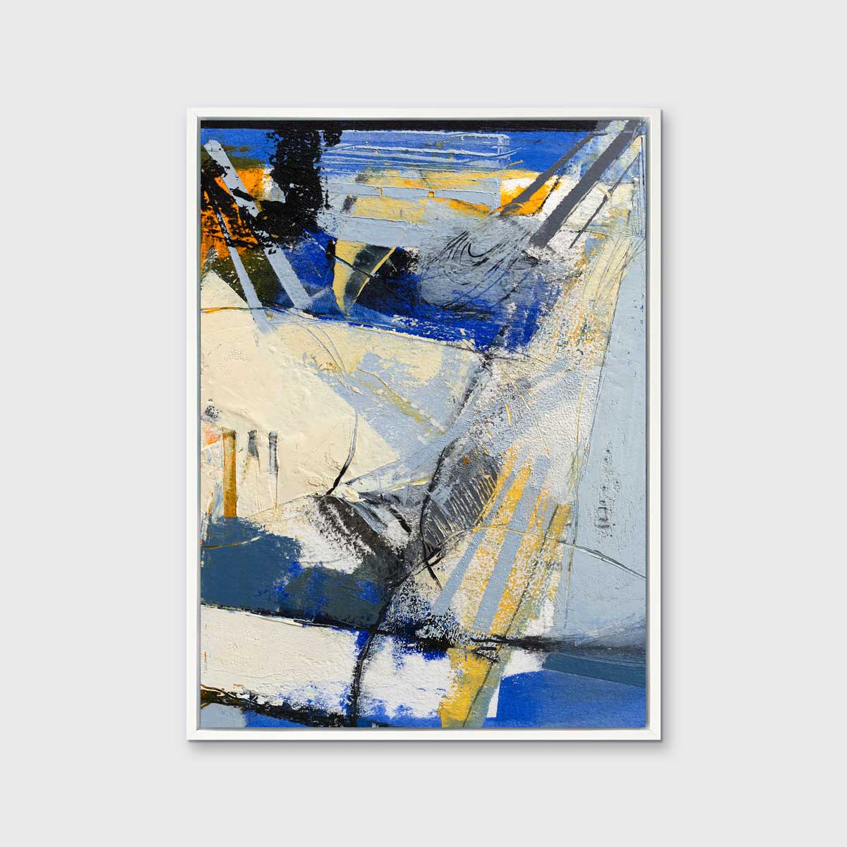 A blue, white, yellow and black abstract print in a white floater frame hangs on a white wall.