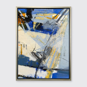 A blue, white, yellow and black abstract print in a silver floater frame hangs on a white wall.