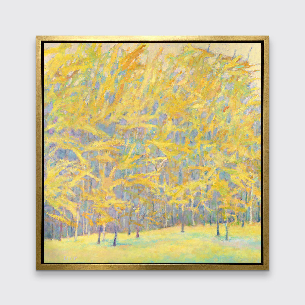 A yellow and blue abstract tree landscape print in a gold floater frame hangs on a white wall.