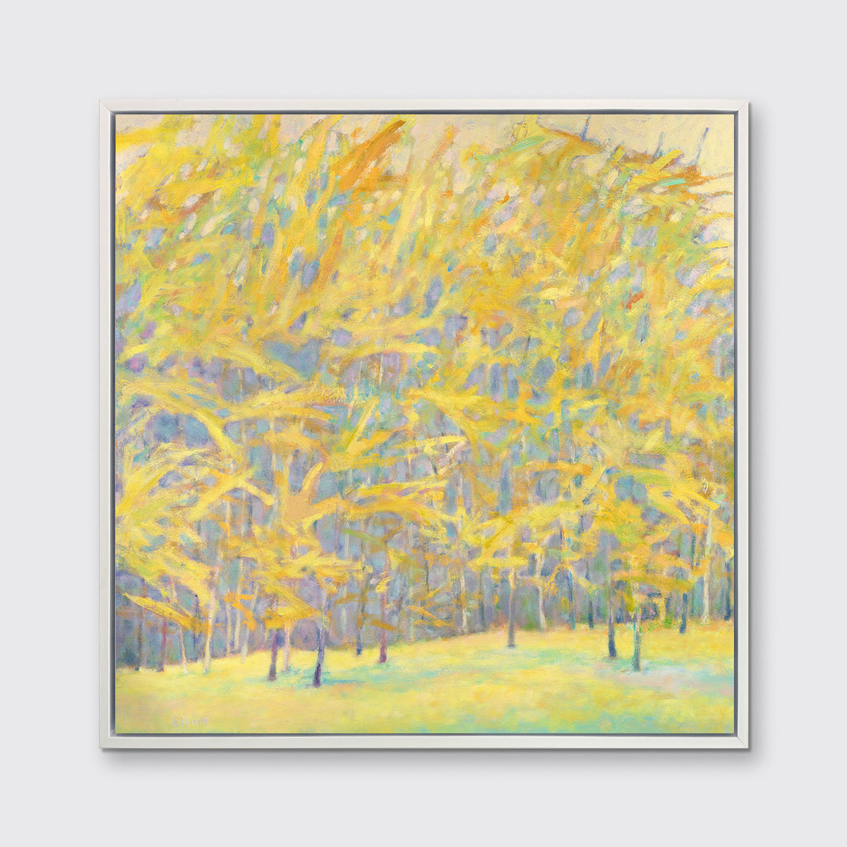 A yellow and blue abstract tree landscape print in a white floater frame hangs on a white wall.