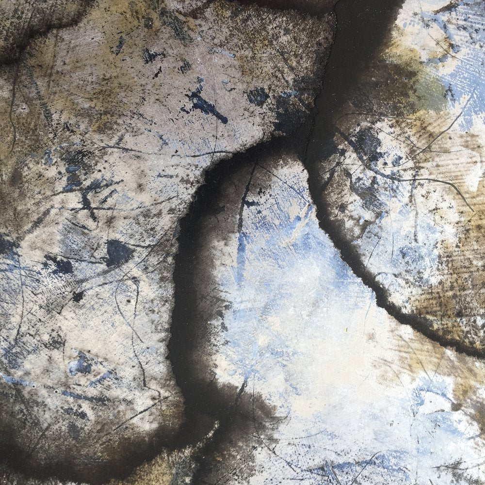 A detail and up close view of a brown, black, blue and white abstract circle painting by Roger Mudre.