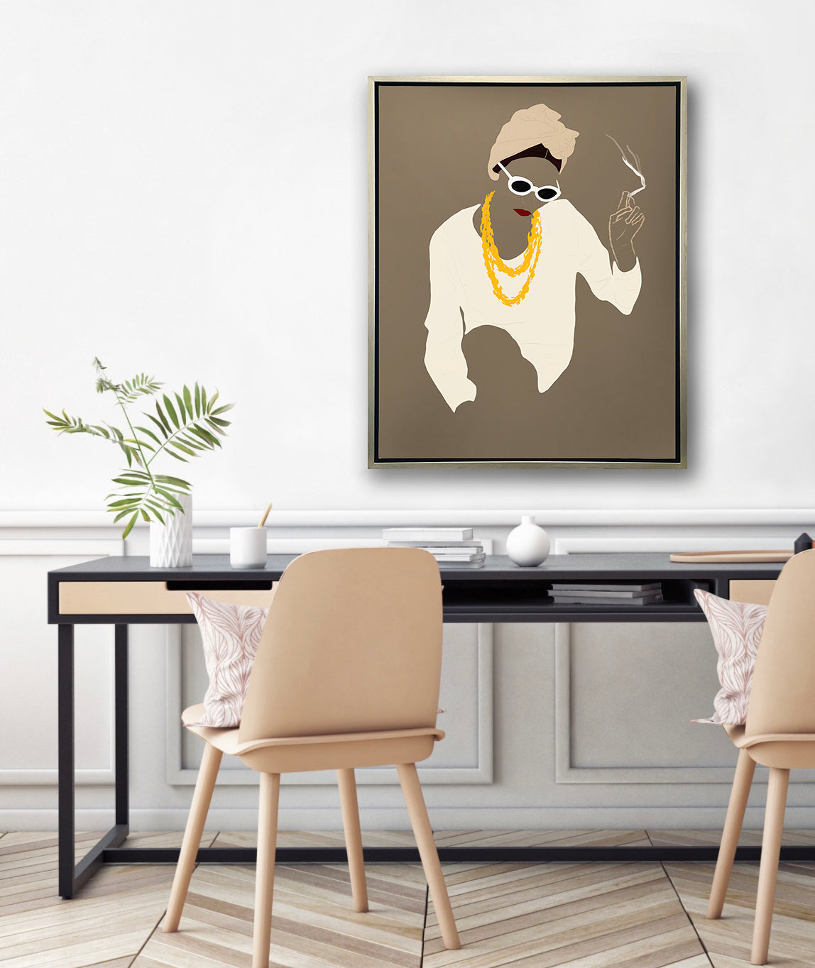 Pop art print of a woman holding a lite cigarette in a silver floater frame hangs above a black desk and natural wood chairs.