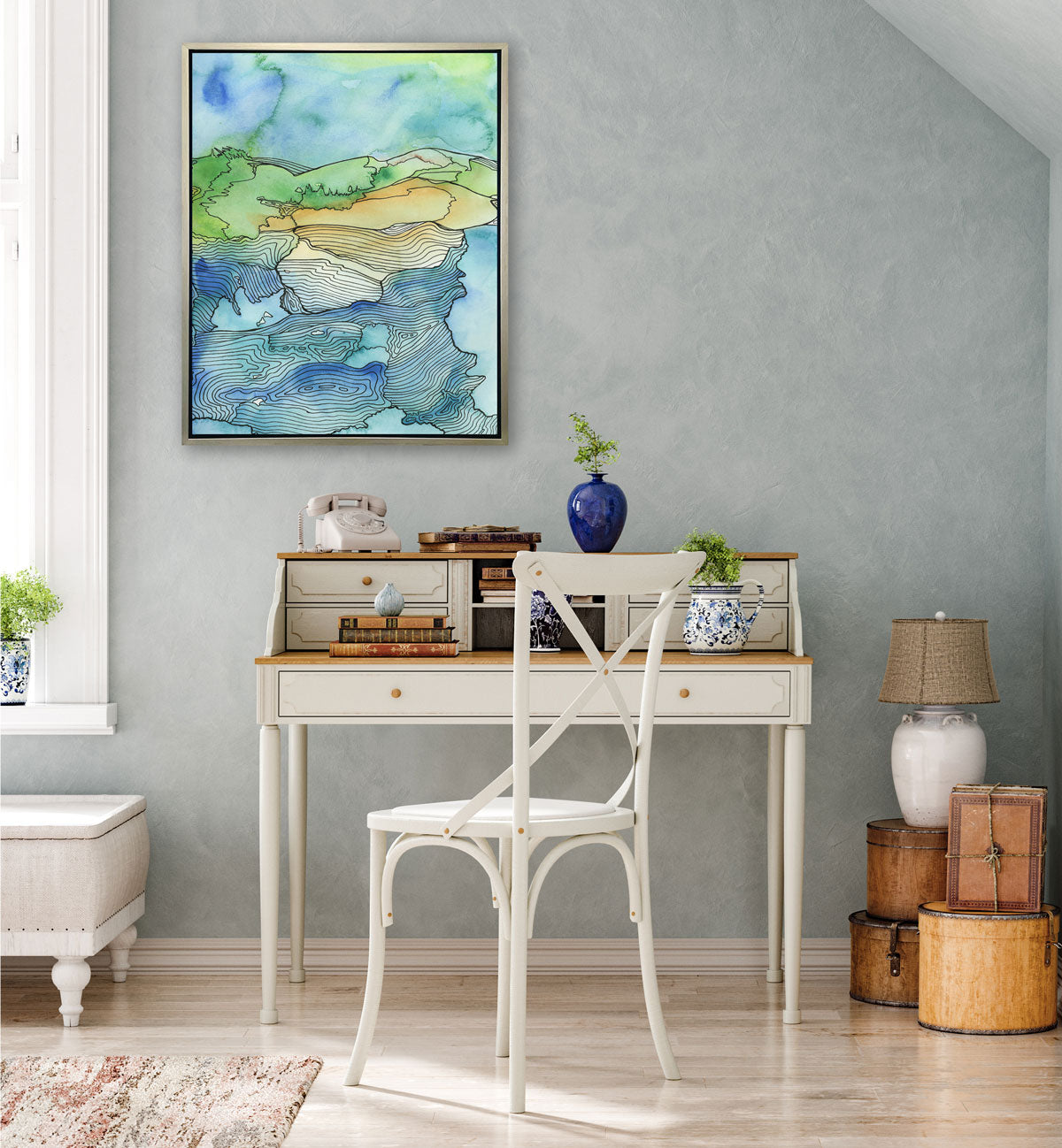 A green and blue illustration print hangs on a grey wall above a traditional desk and vintage decor. 