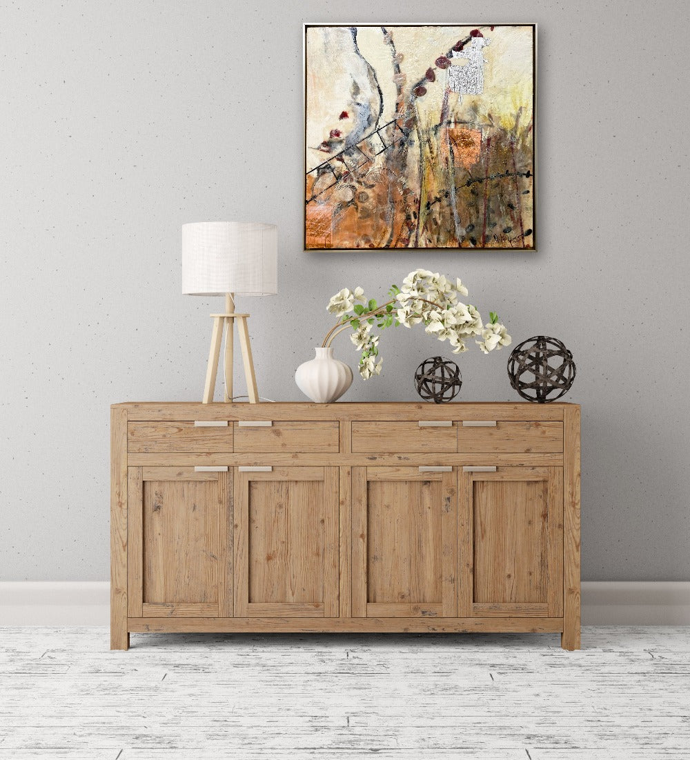 Linda Bigness' painting, Honey Bee Garden, hanging on a grey wall above a natural wood buffet.