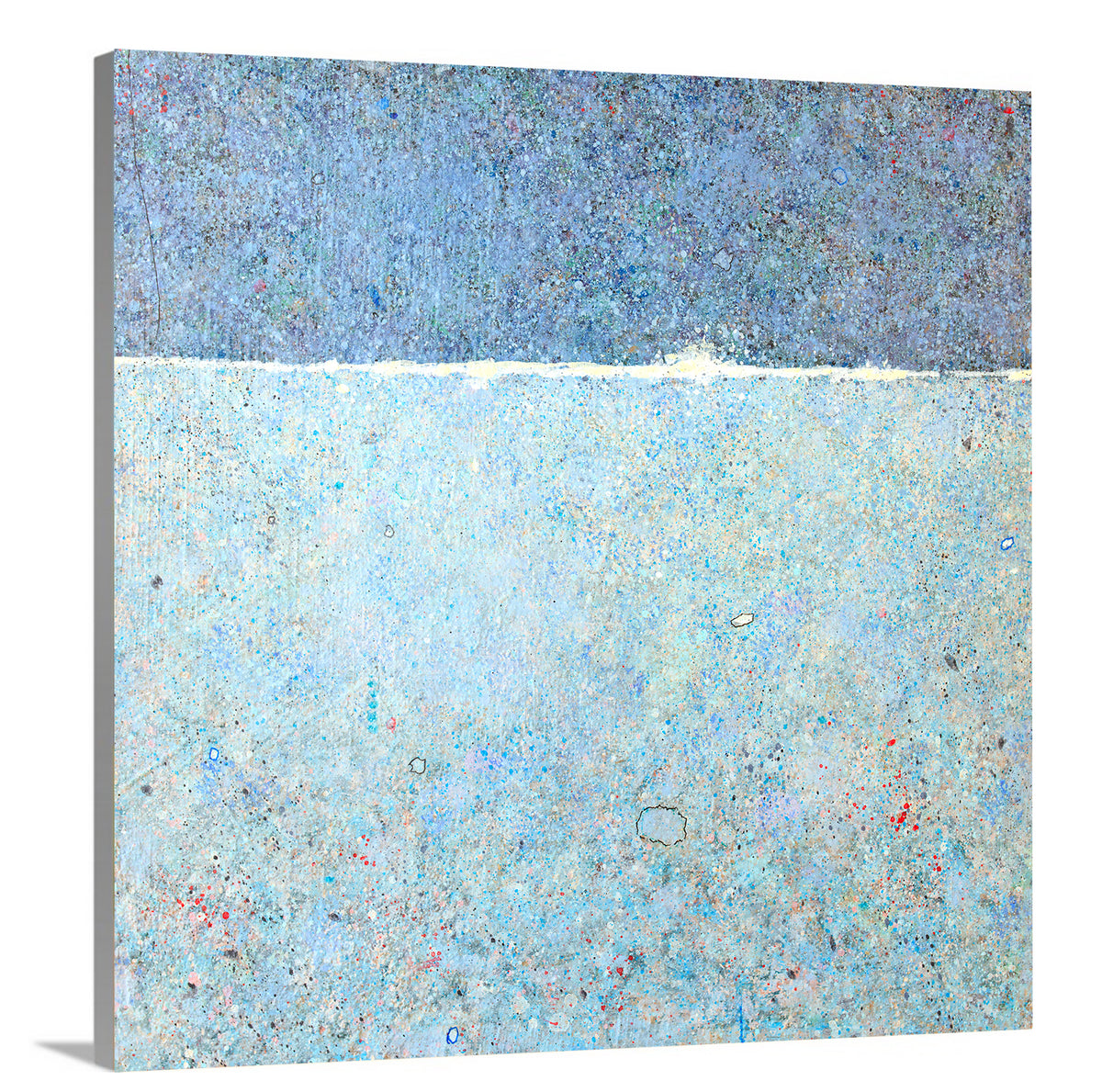 A side-angle view of a blue abstract landscape print on canvas.