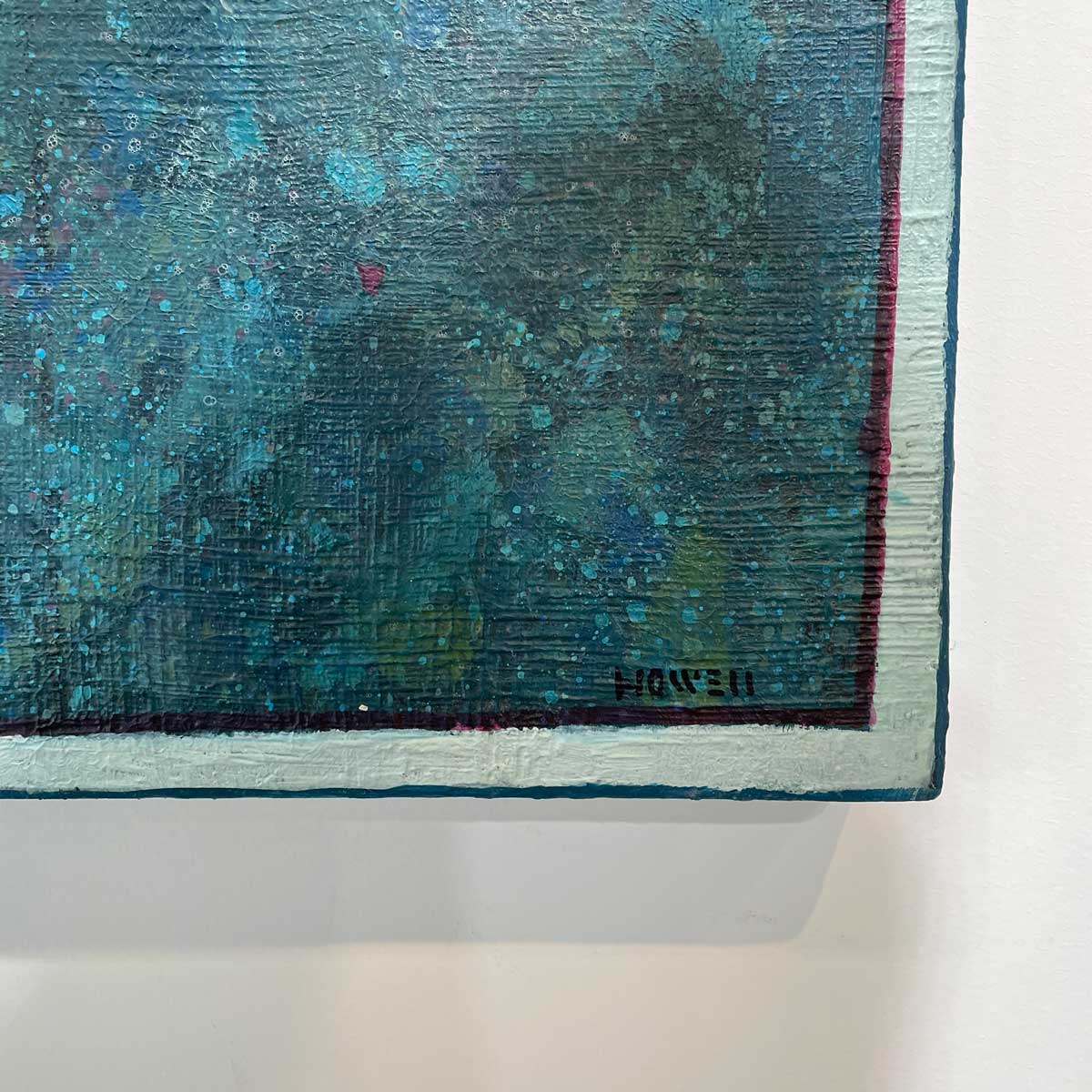A up close detail of the artist's signature in the bottom right-hand corner.