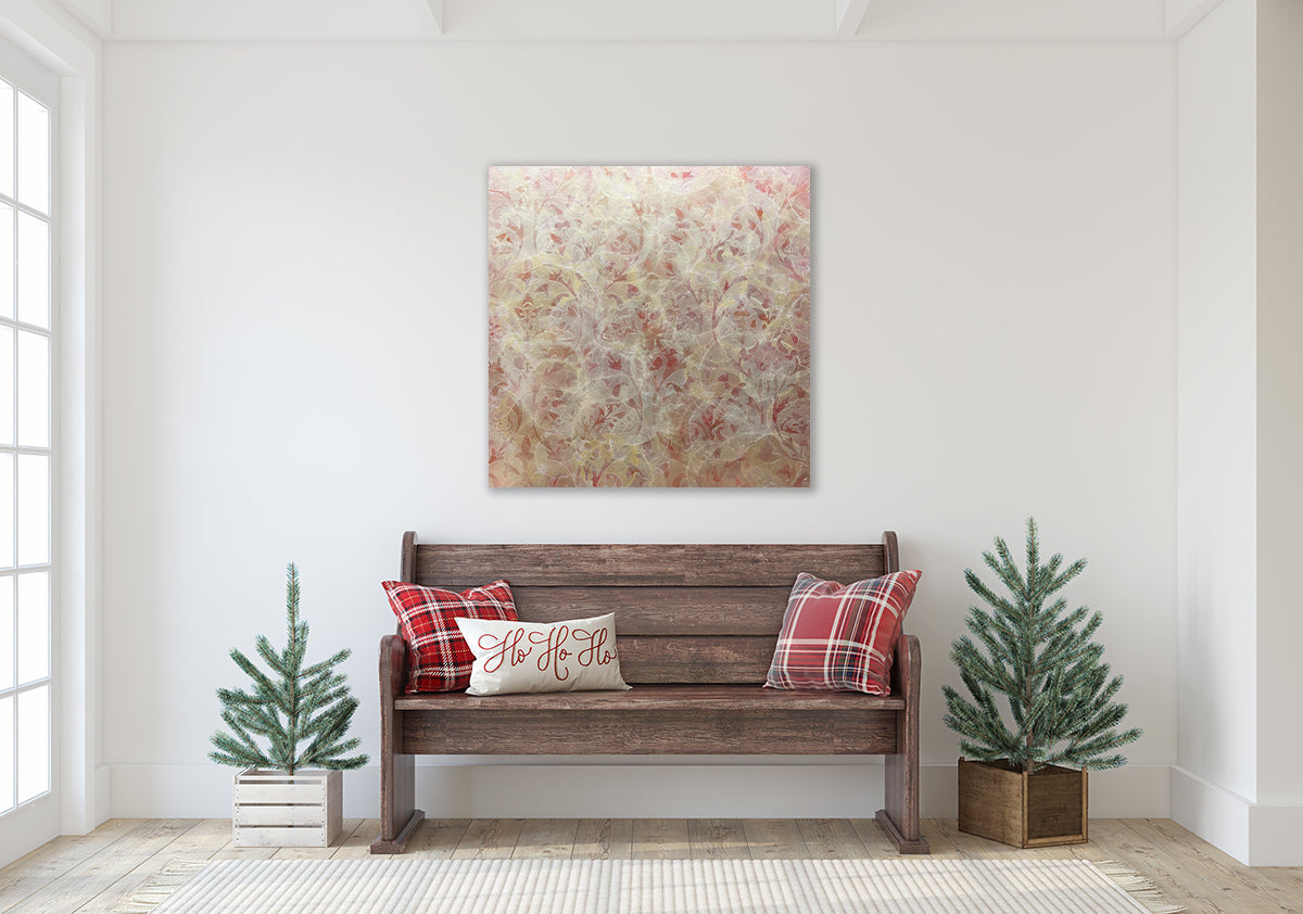 A coral, beige and gold-leaf abstract painting by Roger Mudre above a dark stained wood bench with plaid pillows and two small potted pine trees.